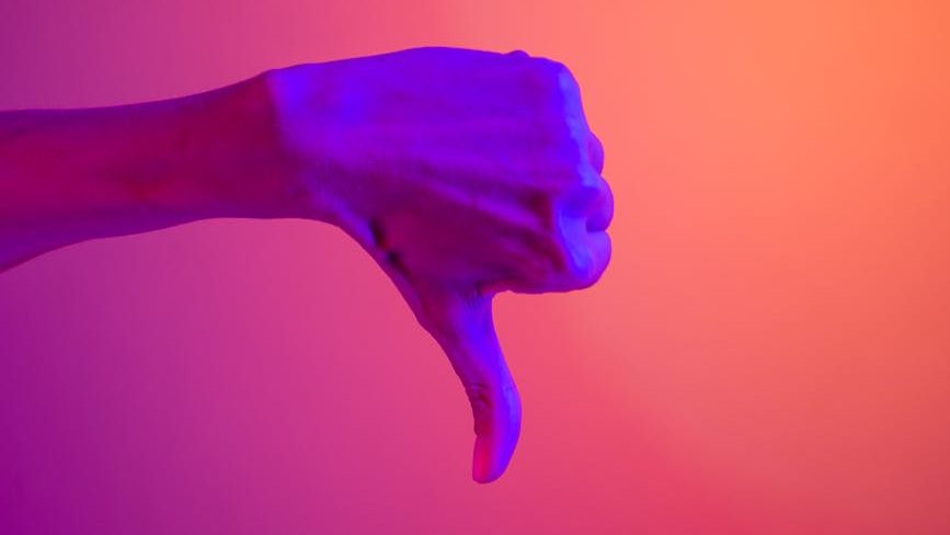 A hand gives the thumbs down sign